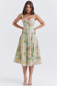Detail of floral spaghetti strap dress showing slit design and green botanical print