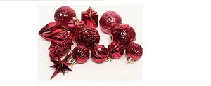 Detail of red Christmas ornaments including shiny stars, pinecones and embossed spheres