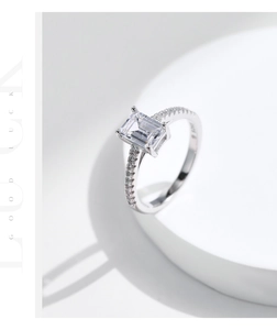 Close-up of S925 sterling silver ring with emerald cut zircon and side pavé diamonds