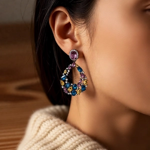 Model wearing vintage drop earrings with teardrop hollow design and multi-color zircons
