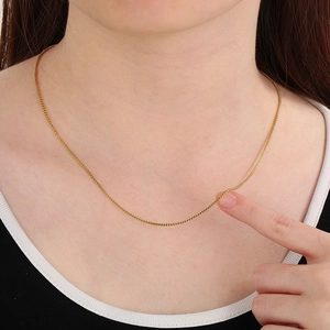 Minimalist gold stainless steel box chain necklace worn by model for casual style