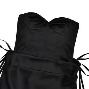 Detail of black corset top featuring heart-shaped neckline, boning structure and side ties