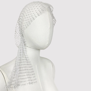Close-up of elegant white mesh fishnet headpiece with pearls on a mannequin head
