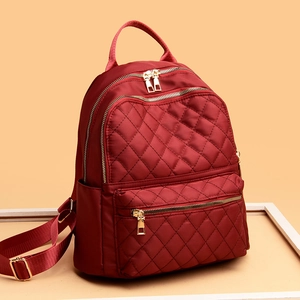 Stylish red quilted oxford cloth backpack for women with gold zippers and large capacity
