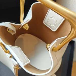 White leather bucket bag with wooden handle and gold metal hardware top view