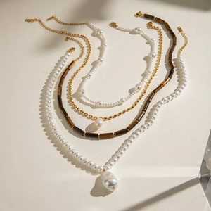 Multi-layer stainless steel necklace featuring pearls and tiger eye stone beads in gold