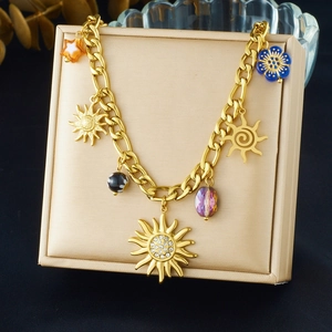 Detail of gold sun pendants and colorful acrylic charms on a vintage style chain