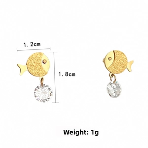 Detail view of fish-shaped gold earrings with dimensions 1.2cm x 1.8cm and crystal drops