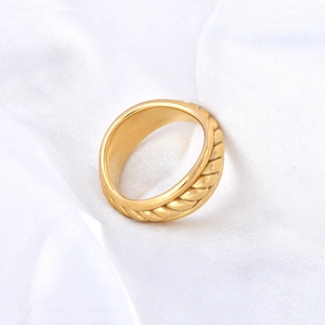 Close-up of 18K gold plated hollow chain ring with twisted rope texture on silk cloth