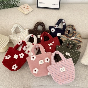 Collection of plush tote bags with floral patterns on a cozy cream textured background