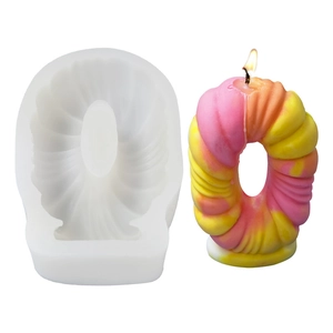 DIY spiral silicone candle mold and multi-color wax ornament on a white background