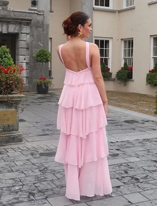 Back view of a pink tiered chiffon maxi dress with open back and delicate ruffles
