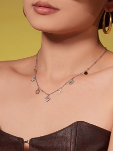Detail of silver layered choker necklace with crystal heart and infinity clover pendants