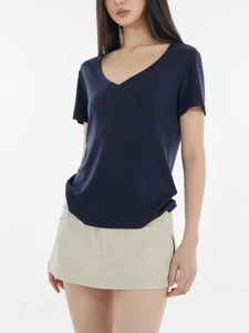 Women's V-neck T-shirt in dark blue tencel wool blend styled with a beige mini skirt