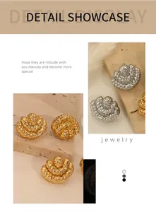 Detailed view of hammered honeycomb texture on gold and silver metallic earrings