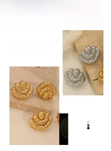 Detailed view of hammered honeycomb texture on gold and silver metallic earrings