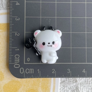 Detailed macro view of 2cm resin Halloween white ghost charm with black horns and trident
