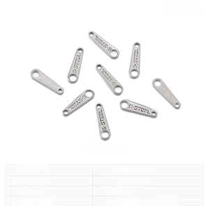 Macro detail of stainless steel jewelry tags showing S.STEEL hallmark and 10x2.7mm size