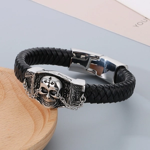Close-up of woven leather bracelet with 316L stainless steel skull and cross detail