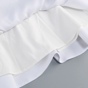 Detail view showing double-layer lining and stitching of the white long sleeve A-line dress