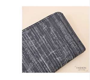 Macro detail of retro striped fabric texture and fine stitching on a ladies' long purse