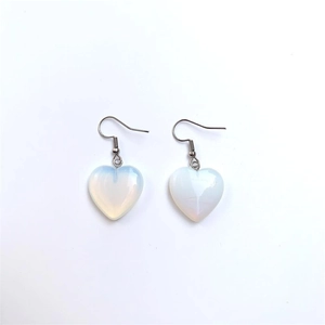 Detailed close-up of heart-shaped opal glass earrings with silver hooks on white background