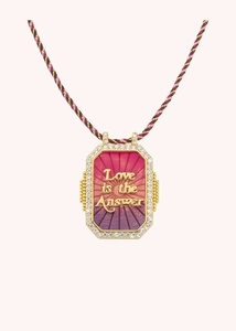 Detail of gold Love is the Answer pendant with pink enamel and sparkling crystals