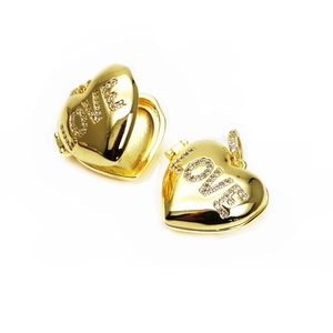 Detail of a gold heart locket showing closed and open views with LOVE rhinestones