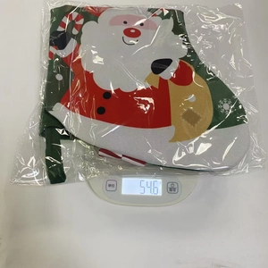 Detailed view of fabric Christmas stocking with Santa Claus design on digital scale