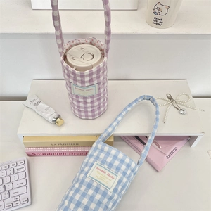 Detailed view of quilted plaid cup holders with long handles in lavender and sky blue