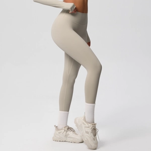 Detail view of high-waisted seamless beige leggings with ergonomic fit and fabric texture