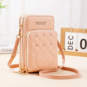 Detailed view of pink quilted heart embroidery on a three-layer zippered crossbody bag