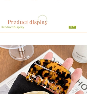 Detailed view of a medium acetate hair claw clip with classic tortoiseshell pattern design