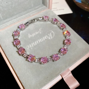 Detail of pink zircon and silver tennis bracelet with folding clasp in a jewelry box