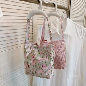 Detailed view of floral and heart jacquard texture on stylish fabric handbags