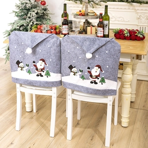 Christmas chair covers featuring grey Santa and snowman prints for festive dining decor