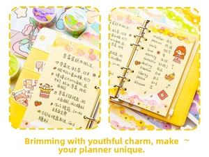 Detail of yellow leather binder notebook with 6-ring metal binder and decorative stickers