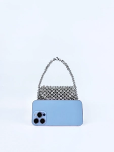 Detail of silver beaded handbag showing texture and size with a blue smartphone reference