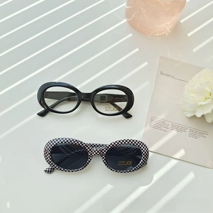 Detail of oval kids sunglasses with UV400 protection and trendy checkerboard patterns