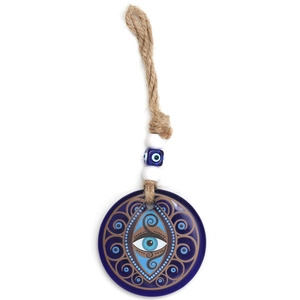 Close-up of blue glass Evil Eye pendant with golden decorative patterns and rope beads