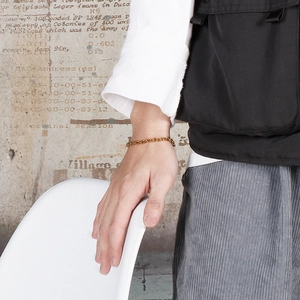 Detail shot of a minimalist 18k gold-plated stainless steel O-chain bracelet on wrist