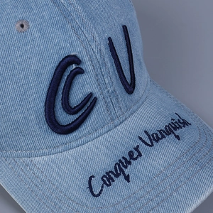 Light blue washed denim baseball cap with navy embroidery of CV and Conquer Vanquish text