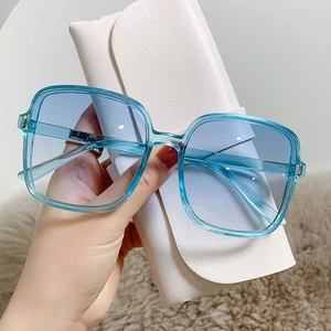 Square oversized sunglasses featuring gradient blue lenses and translucent blue frames