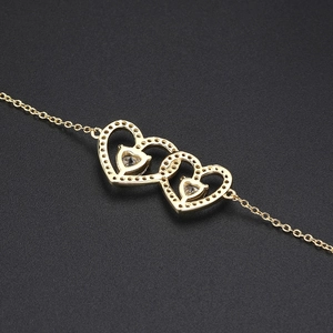 Elegant gold bracelet featuring three interlocking hollow hearts set with cubic zirconia
