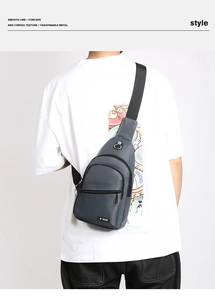 Detail of dark grey water-resistant oxford fabric chest bag with zipper and metal logo