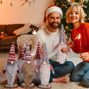 Set of six Christmas gnome decorations with long beards and wooden bases for table decor