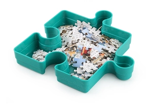 Close-up of a turquoise jigsaw puzzle sorting tray showing plastic storage with pieces