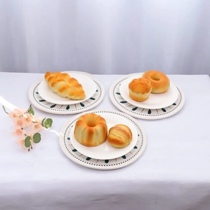 Five assorted artificial bread models on a decorative mat for elegant home kitchen decor