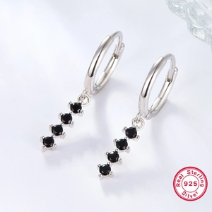 Macro shot of sterling silver earrings featuring four vertical round black cubic zirconia