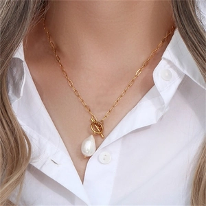 Close-up of baroque pearl pendant on gold stainless steel chain with OT clasp toggle